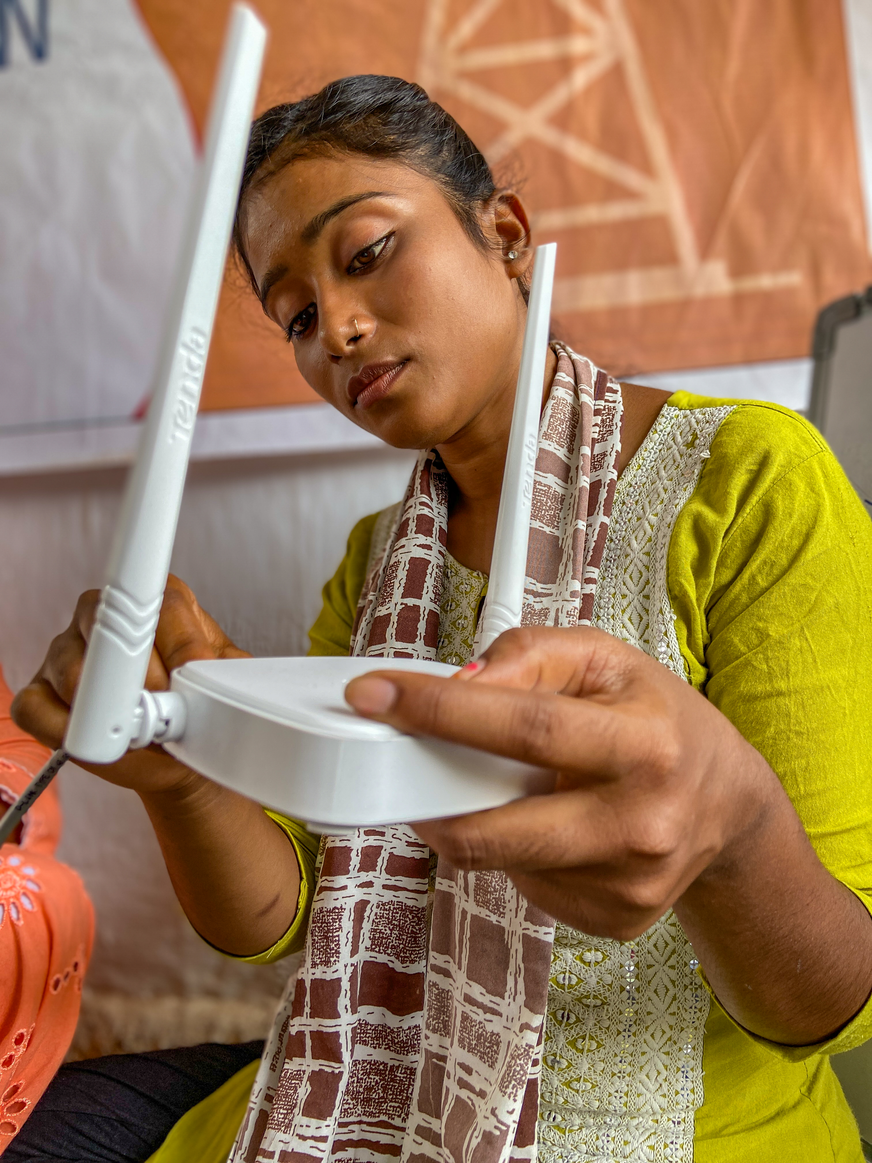 A woman in rural India setting up and configuring a wireless network router during training under DEF’s Women Wireless Engineers programme