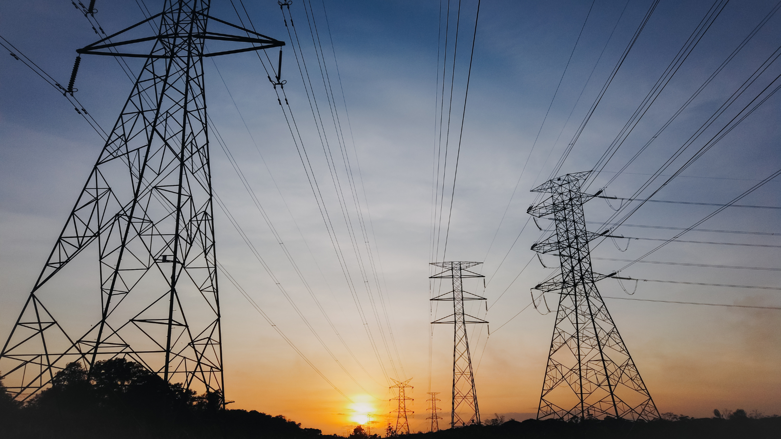 Silhouette of electricity towers during sunset