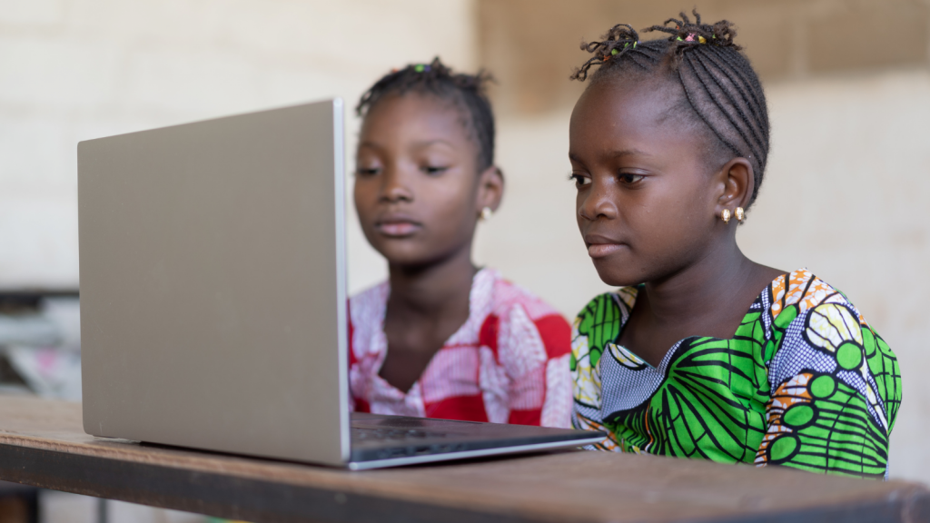 Two African girl using a computer in a classroom